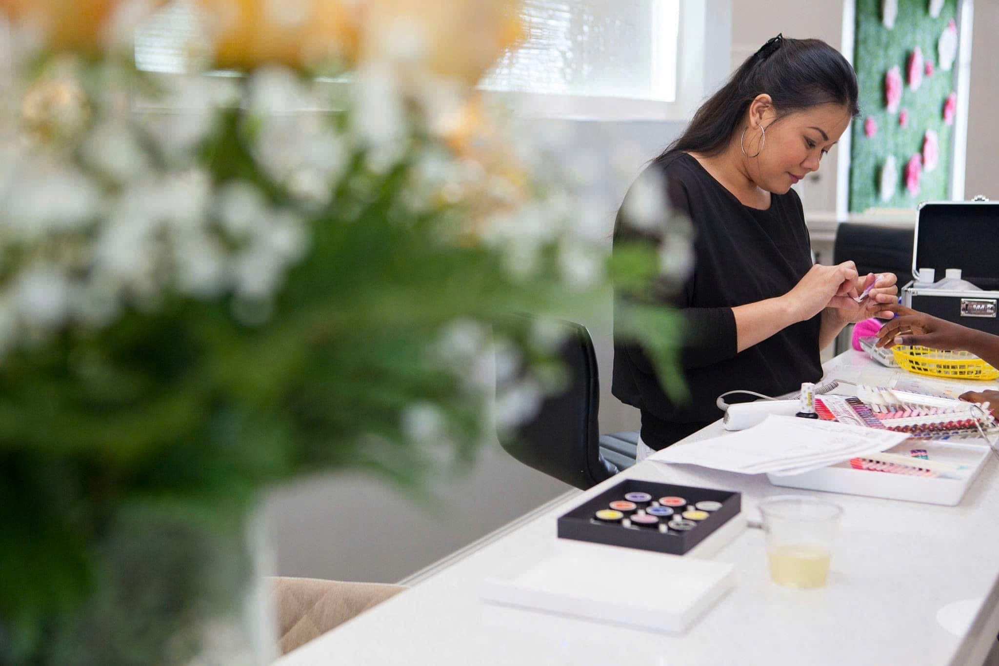 Luxia nail artisan crafting a manicure at the studio bar