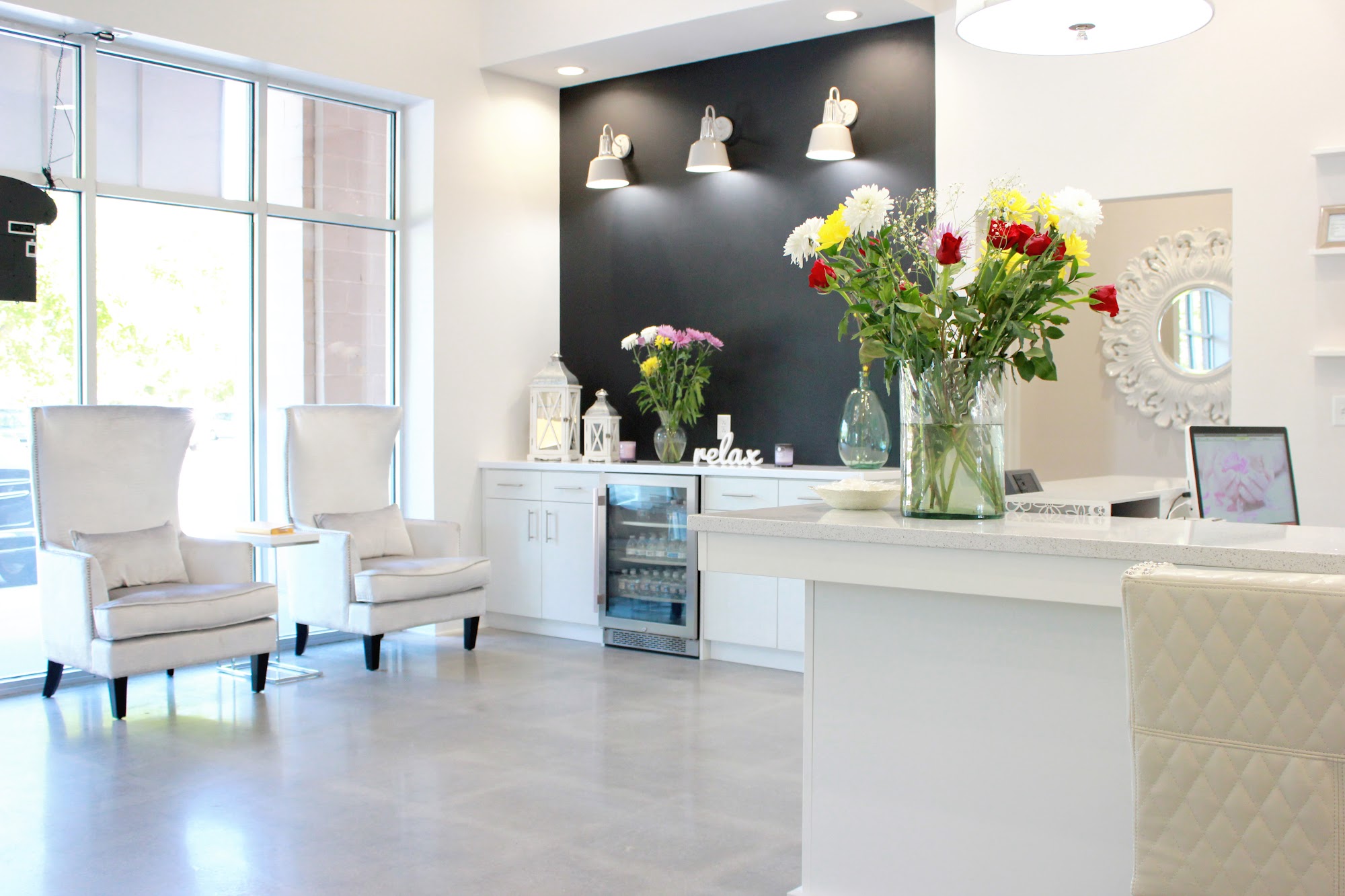 Northbridge reception lobby with crystal chandelier, dark accent wall, and fresh flowers